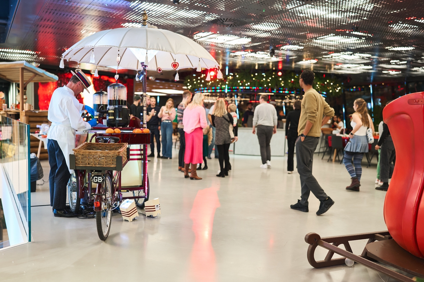 People in the breakout space socalising after a social with food stalls set up